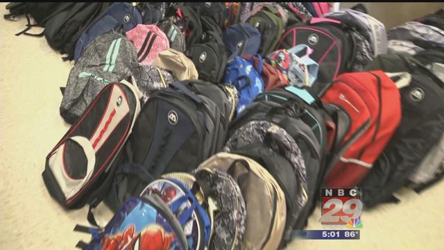State Farm Employees Hand Out Dozens of Backpacks Filled with School Essentials